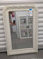 Front view of ivory filigree wall mirror