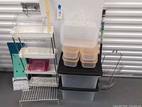 Group shot showing entire assortment: rolling cart, storage boxes, orange-lid containers, shower caddy, tension rod, folding boards, wire riser, acrylic pieces