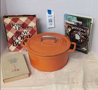 Group view of Dutch oven with lid and three cookbooks