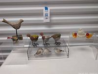 Group shot showing all bird figurines on display stands