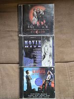Front covers of the three CDs stacked vertically