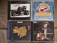 Front covers of all four CDs in jewel cases
