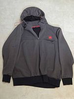 Full view of front of hoodie showing color scheme, half-zip, hood, pocket, ribbing, visible wear