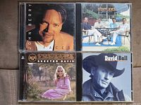 Front covers of all four country music CDs in jewel cases