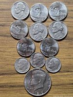 All 12 coins laid out showing obverse designs