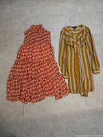 Both dresses laid flat front view