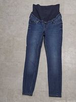 Front view of jeans showing full length and ribbed maternity panel