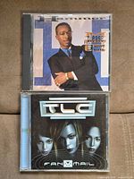 Front covers of MC Hammer and TLC CDs in jewel cases