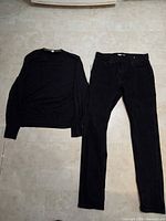 Sweater and jeans laid flat showing overall condition and color