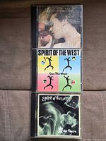 Front covers of the three Spirit of the West CDs