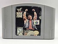 Front of WWF War Zone N64 cartridge showing worn label