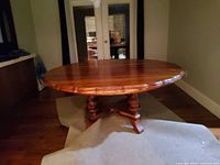 Round teak dining table on pedestal base
