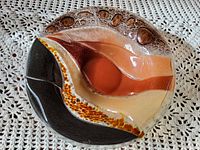 Top view of fused glass bowl showing color segments and rim texture