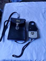 Meter and closed leather pouch with strap