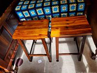 Top view of both bar stools showing wood grain and construction