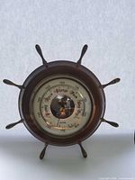 Front view of Stockberger ship’s wheel barometer showing dial and spokes