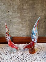Front angled view of both Murano glass pheasant figurines showing confetti wings and red bodies