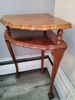 full view of two-tier corner table in room corner