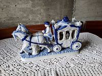 Right side view of entire porcelain carriage figurine