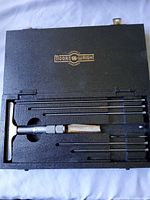 Open case with depth micrometer head and rods