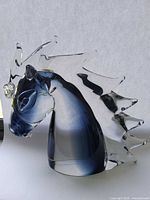 Full right-side view of clear and blue glass horse head