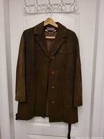 Front view of dark brown suede jacket showing red buttons and lapel