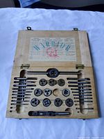 open box showing full set of taps, dies, handles
