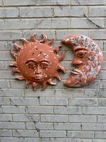 Front view of both clay plaques on brick wall