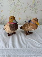 Both duck figurines front view on table