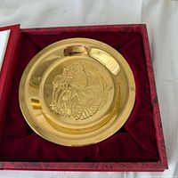 Plate in open presentation box showing relief design