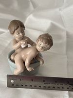 Front view of figurine with ruler showing scale