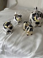 Four cow pieces displayed