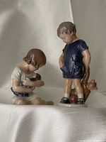 Both Royal Copenhagen child figurines front view