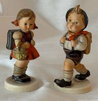 Front view of both figurines standing side by side