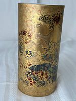 Front view showing gilt figural and floral motif with multicolor accents