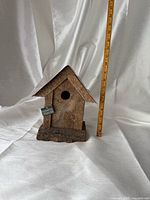 Front view of birdhouse with ruler indicating height