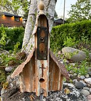 Front view showing full birdhouse, keyhole plate, perch, cross, bell