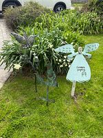 All three metal garden stakes standing in yard