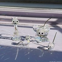 Group shot of four crystal figurines catching light