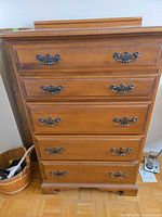 Front view of 5-drawer dresser showing drawers and metal handles