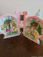 Open hinged village hotel showing both interior panels with rabbit and chick scene