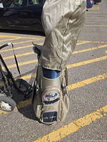 Fila golf bag with beige headcover on push cart