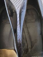Insoles showing STUART branding and interior wear
