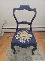 Full front view of chair showing frame and upholstered seat