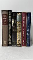 Spines of all six Folio Society volumes side by side