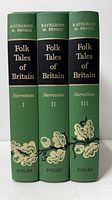 Spines of the three green hardcovers showing titles and volume numbers