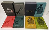 Group shot of both slipcased sets with six books displayed