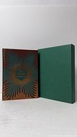 Front cover of book beside green slipcase
