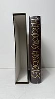 Book spine with gilt title beside empty slipcase