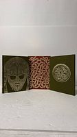 Both covers of one volume displayed to show gilt/black stamped designs